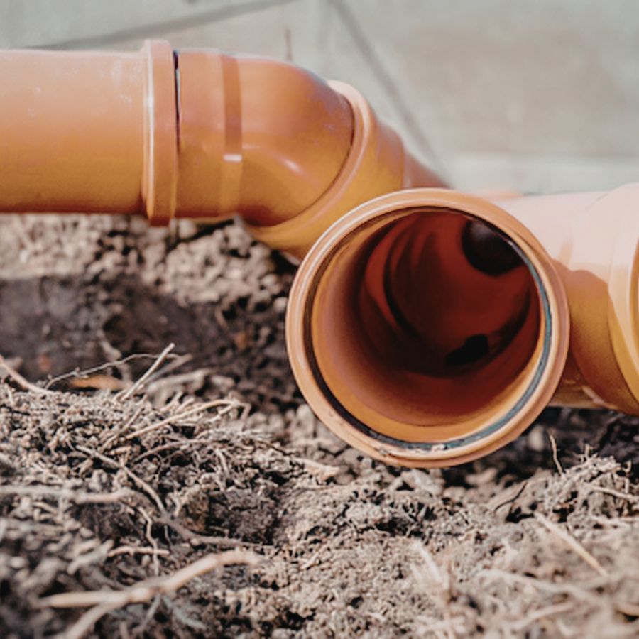 underground drainage pipes being laid in a trench