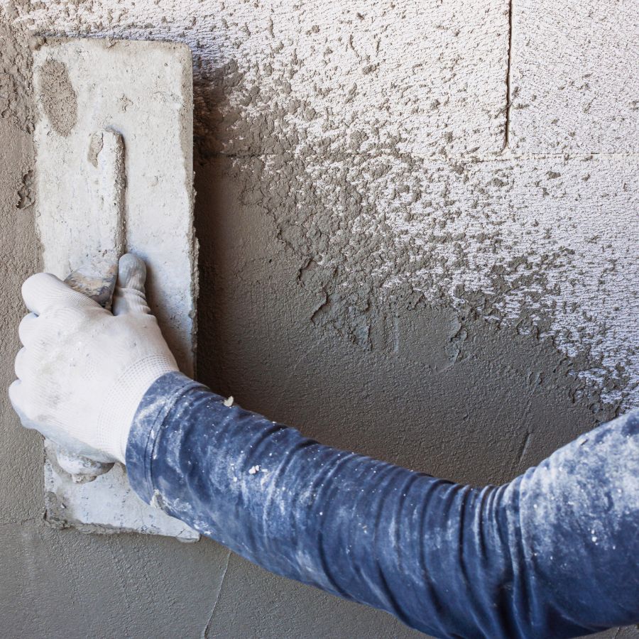 base coat plaster applied to brick wall