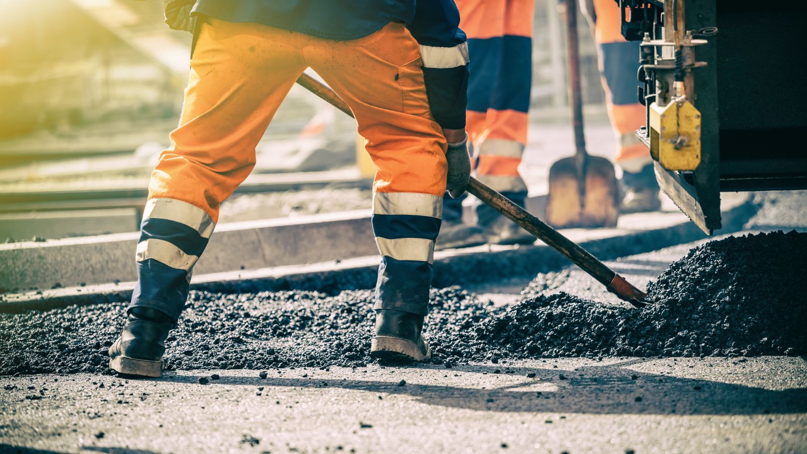 asphalt paver laying fresh asphalt on a road