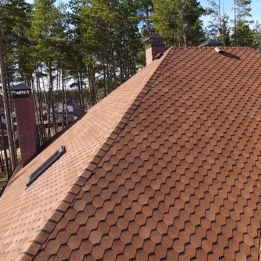 roofer fitting sheet material on a rooftop